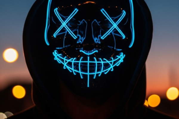 Mysterious Hooded Figure with Glowing Blue Neon Mask at Twilight Mobile Wallpaper Mobile wallpaper